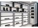 Custom closet features designer items on display and lighted shelving at 1429 Iron Hills Ln, Las Vegas, NV 89134
