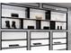 Custom closet features designer items on display and lighted shelving at 1429 Iron Hills Ln, Las Vegas, NV 89134