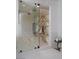 Glass shower with elegant stone and dual shower heads at 1429 Iron Hills Ln, Las Vegas, NV 89134