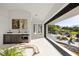 Sitting area with modern wet bar and sliding glass doors to the pool and outdoor living at 1429 Iron Hills Ln, Las Vegas, NV 89134