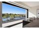Seamless indoor/outdoor view, with pond, manicured landscaping, and seating at 1429 Iron Hills Ln, Las Vegas, NV 89134