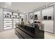 Bright walk-in closet with custom storage and black display island at 1429 Iron Hills Ln, Las Vegas, NV 89134