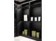 Stylish walk-in closet boasts black cabinetry and shelving for ample storage at 1429 Iron Hills Ln, Las Vegas, NV 89134