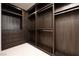 Walk-in closet with custom wood cabinetry and shelving provides ample storage space at 1429 Iron Hills Ln, Las Vegas, NV 89134