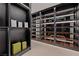 Beautiful walk-in closet features modern wood shelving, gray cabinetry, and recessed lighting at 1429 Iron Hills Ln, Las Vegas, NV 89134