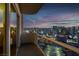 Step out onto this condo balcony and soak in the dazzling city lights, framed by a colorful twilight sky at 145 E Harmon Ave # 3705, Las Vegas, NV 89109