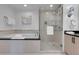 Well-lit bathroom with a soaking tub and a separate glass-enclosed shower with sleek fixtures at 145 E Harmon Ave # 3705, Las Vegas, NV 89109