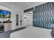 Modern bedroom featuring stylish wallpaper, a convenient wet bar, and comfortable furnishings at 145 E Harmon Ave # 3705, Las Vegas, NV 89109