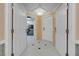 Bright hallway boasts a tile floor pattern with decorative accent, neutral paint and white doors and trim throughout at 145 E Harmon Ave # 3705, Las Vegas, NV 89109