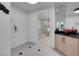 Hallway view leading to a bathroom with a soaking tub and a glass-enclosed shower at 145 E Harmon Ave # 3705, Las Vegas, NV 89109