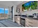 Modern kitchenette with stainless steel appliances, dark granite countertops, and a view from the adjacent window at 145 E Harmon Ave # 3705, Las Vegas, NV 89109