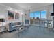 Sun-filled living room with comfortable seating, barstools and expansive city views from the large glass patio doors at 145 E Harmon Ave # 3705, Las Vegas, NV 89109