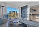 Bright living room area features comfortable seating and barstools that face the large window with an expansive view at 145 E Harmon Ave # 3705, Las Vegas, NV 89109
