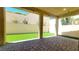 The covered back patio features brick pavers and overlooks an artificial turf lawn at 145 Forest Crossing Ct, Las Vegas, NV 89148