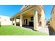 View of the backyard that features a covered patio, turf lawn, brick pavers, and a gate at 145 Forest Crossing Ct, Las Vegas, NV 89148