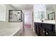 Bathroom featuring double vanity, separate tub and shower with sleek black trim at 145 Forest Crossing Ct, Las Vegas, NV 89148