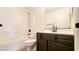 A clean bathroom with a white shower, vanity, toilet, and dark fixtures at 145 Forest Crossing Ct, Las Vegas, NV 89148