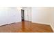 A secondary bedroom with hardwood floors, white baseboards, and white doors at 145 Forest Crossing Ct, Las Vegas, NV 89148