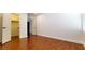 A vacant bedroom is brightly lit with hardwood floors, white walls, and a closet at 145 Forest Crossing Ct, Las Vegas, NV 89148