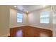 Bright bedroom with hardwood floors and natural light from two windows at 145 Forest Crossing Ct, Las Vegas, NV 89148