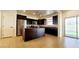 Stylish kitchen with dark wood cabinets, stainless steel appliances, and a granite island with bar seating at 145 Forest Crossing Ct, Las Vegas, NV 89148