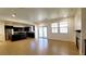 Open-concept living space features a modern kitchen, tile floors, and a seamless flow to the outdoor patio at 145 Forest Crossing Ct, Las Vegas, NV 89148