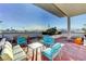 A furnished rooftop deck features comfortable lounge furniture and city views at 150 Las Vegas Blvd # 1716, Las Vegas, NV 89101