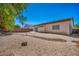 The backyard boasts desert landscaping and a patio area, perfect for outdoor enjoyment at 1604 Lazy Hill Ranch Way, North Las Vegas, NV 89081