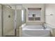 Bright bathroom featuring a separate soaking tub and glass-enclosed shower at 1604 Lazy Hill Ranch Way, North Las Vegas, NV 89081