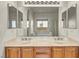 Bathroom vanity with double sinks and mirrors at 1604 Lazy Hill Ranch Way, North Las Vegas, NV 89081