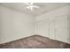 This bedroom features neutral walls, carpeted floors, a ceiling fan, and closet at 1604 Lazy Hill Ranch Way, North Las Vegas, NV 89081