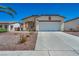 Charming single-story home with a well-manicured desert rock front yard and an attached two-car garage at 1604 Lazy Hill Ranch Way, North Las Vegas, NV 89081