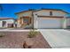 Charming single-story home with a well-manicured desert rock front yard and an attached two-car garage at 1604 Lazy Hill Ranch Way, North Las Vegas, NV 89081