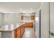 Bright kitchen featuring wood cabinets, an island, and modern white appliances at 1604 Lazy Hill Ranch Way, North Las Vegas, NV 89081