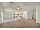 Spacious living area features an open floor plan, ceiling fan, and kitchen view at 1604 Lazy Hill Ranch Way, North Las Vegas, NV 89081