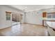 Open living area features tile flooring, sliding doors, and a view of the kitchen at 1604 Lazy Hill Ranch Way, North Las Vegas, NV 89081
