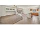 Open-concept living room and kitchen area with tile and carpet flooring at 1604 Lazy Hill Ranch Way, North Las Vegas, NV 89081