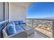 Balcony features comfortable seating with stunning city views beyond the railing at 200 W Sahara Ave # 2210, Las Vegas, NV 89102