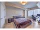 Spacious bedroom featuring travertine flooring, desk area, and large window with blinds at 200 W Sahara Ave # 2210, Las Vegas, NV 89102