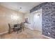 Modern dining area features stylish light fixture, dining set, and stone accent wall at 200 W Sahara Ave # 2210, Las Vegas, NV 89102