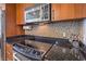 Modern kitchen features granite countertops, stainless steel appliances, and tiled backsplash at 200 W Sahara Ave # 2210, Las Vegas, NV 89102