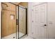 Stunning walk-in shower with wood-look tile, matte black hardware, and a built-in shower niche at 2149 Kelsey Creek Ct, Henderson, NV 89044