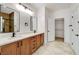 Modern bathroom featuring double sinks, quartz countertops, wood cabinets, and a walk-in closet at 2149 Kelsey Creek Ct, Henderson, NV 89044