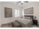 Comfortable bedroom with neutral tones, stylish decor, and a large window for natural light at 2149 Kelsey Creek Ct, Henderson, NV 89044
