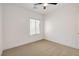 A clean bedroom with neutral carpet, minimalist details, and a single large window with window shades at 2149 Kelsey Creek Ct, Henderson, NV 89044