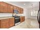 Well-lit kitchen featuring wood cabinetry, granite countertops, and stainless steel appliances at 2149 Kelsey Creek Ct, Henderson, NV 89044