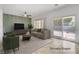 Bright living room with stylish decor, neutral tones, and sliding door access to the backyard at 2149 Kelsey Creek Ct, Henderson, NV 89044