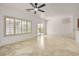 Open living area with tile floors, ceiling fan, and natural light coming in through a large set of windows at 2149 Kelsey Creek Ct, Henderson, NV 89044