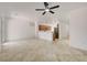 Open living area with ceiling fan and tile floors that flows into the kitchen with stainless appliances at 2149 Kelsey Creek Ct, Henderson, NV 89044