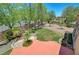 Lush backyard features a decorative pond, trees, shrubs, and a small grassy area at 229 N Buteo Woods Ln, Las Vegas, NV 89144